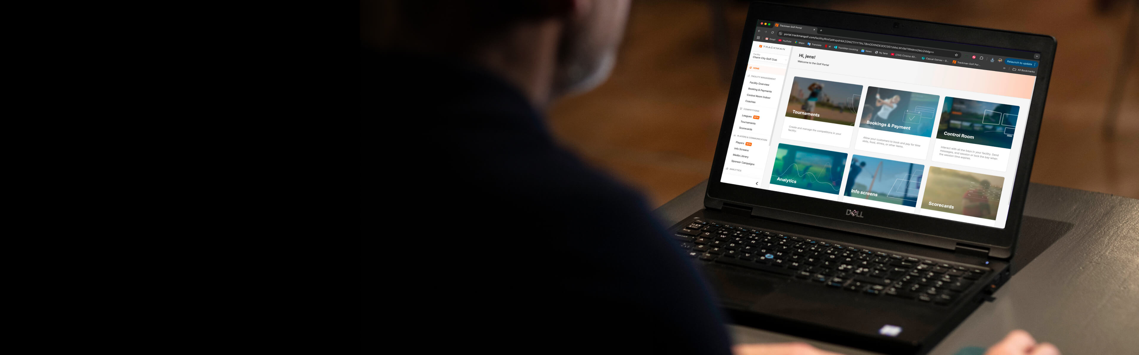 Person using a Dell laptop displaying a website Trackman Booking and Payments